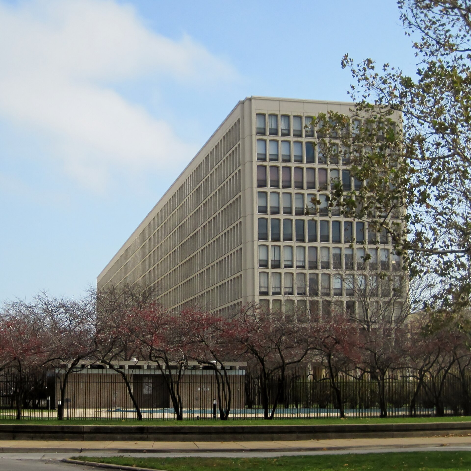 A long modernist apartment slab, University Apartments, standing in the median of 55th Street in Hyde Park.